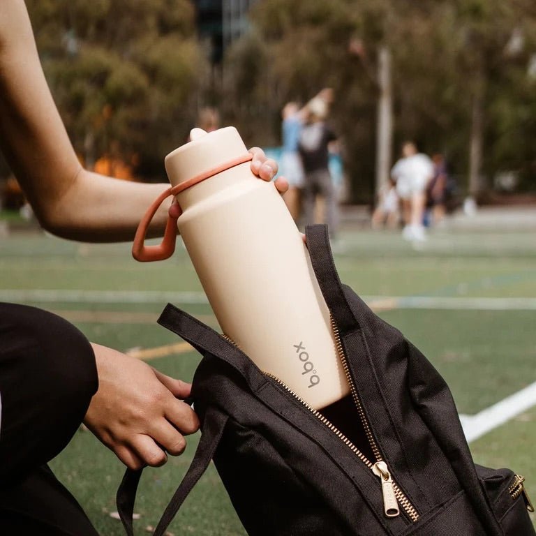 bbox flip top 1 litre insulated stainless steel drink bottle in melon mist orange peach colour in backpack