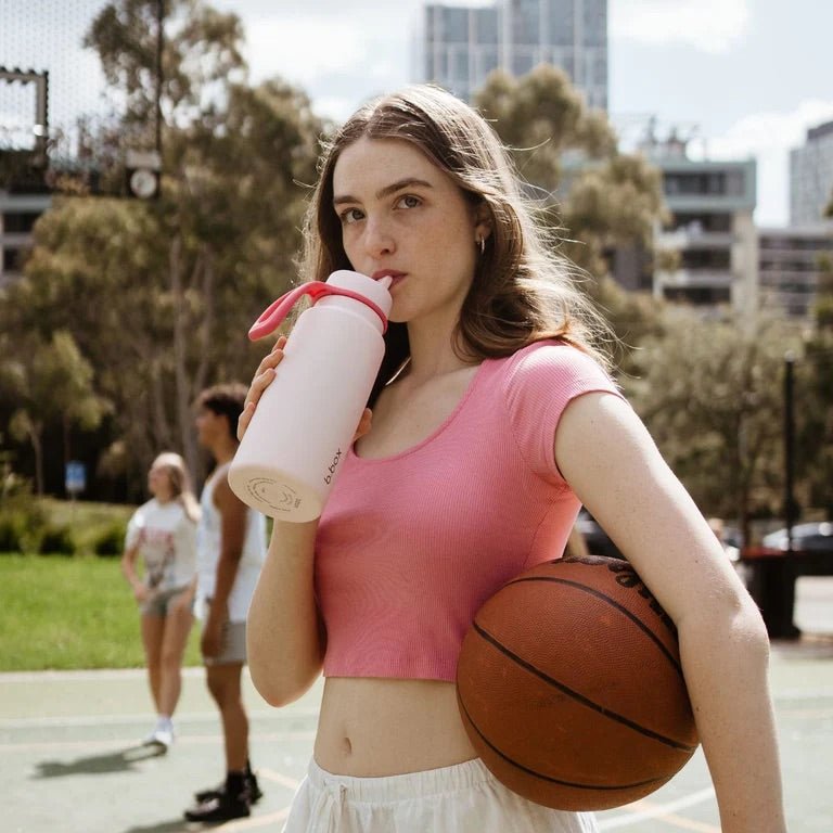 bbox flip top 1 litre insulated stainless steel drink bottle in pink paradise colour on the field