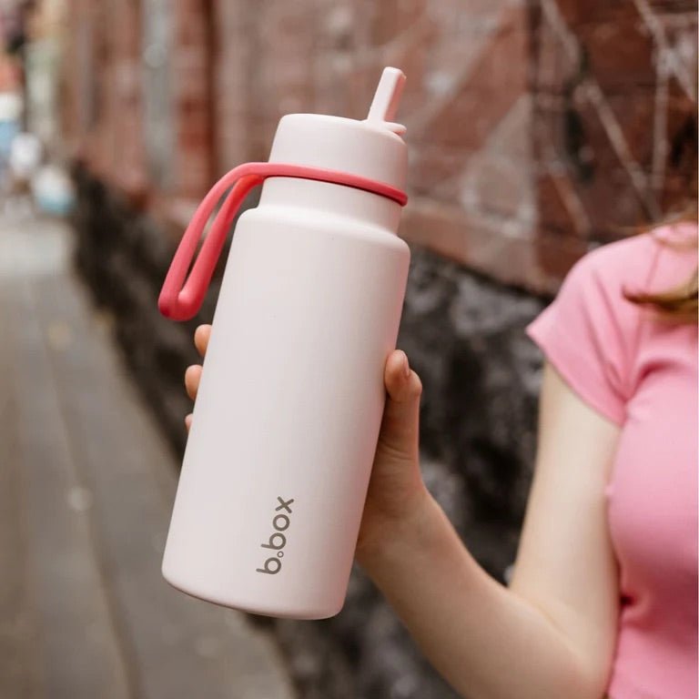 bbox flip top 1 litre insulated stainless steel drink bottle in pink paradise colour held in hand